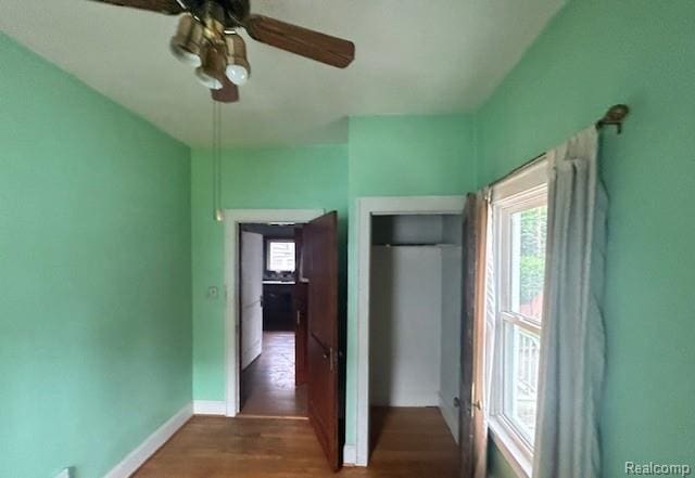 2170 Avondale St, Sylvan Lake, MI 48320 - unfurnished bedroom featuring wood finished floors, a ceiling fan, and a closet