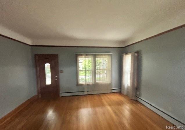 2170 Avondale St, Sylvan Lake, MI 48320 - entryway with a baseboard radiator, light wood-type flooring, and crown molding