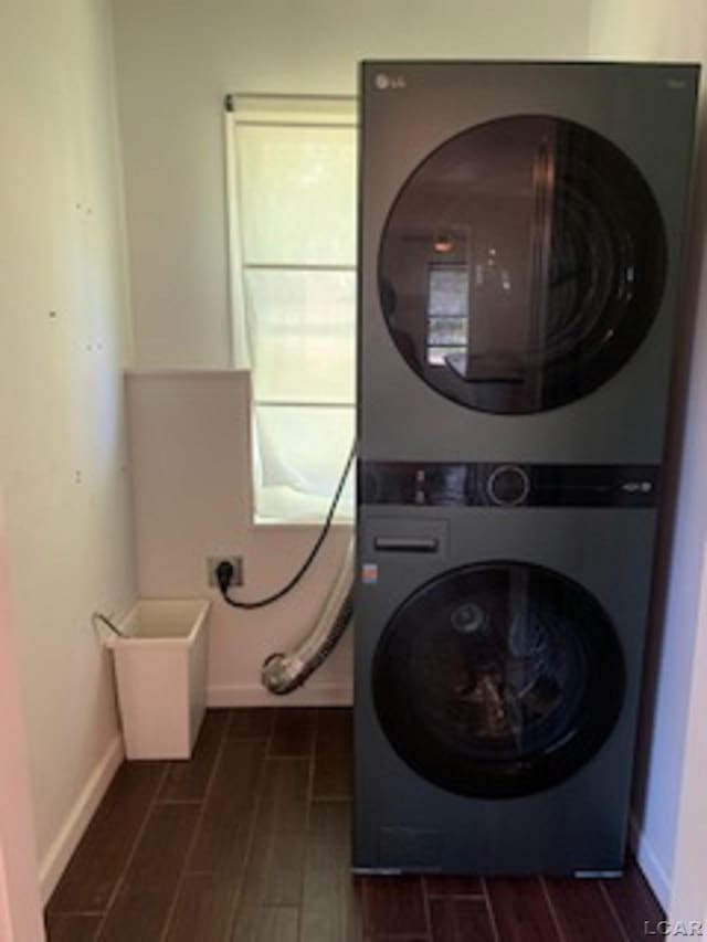 609 Orchard Ln, Tecumseh, MI 49286 - washroom featuring stacked washer / drying machine and wood finish floors