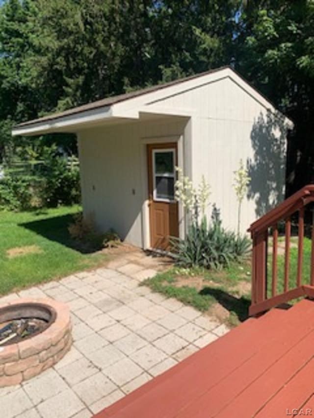 609 Orchard Ln, Tecumseh, MI 49286 - view of outdoor structure featuring an outdoor fire pit