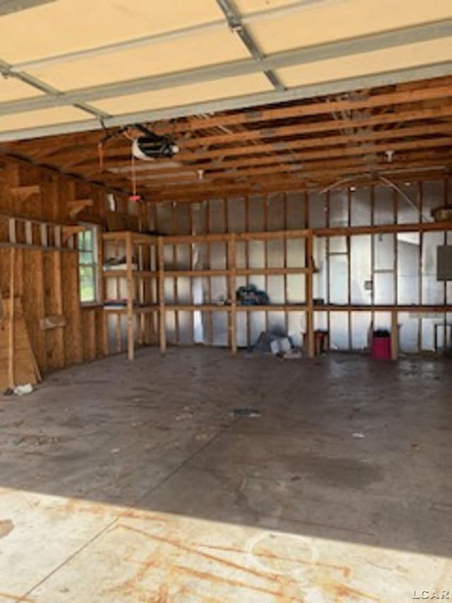 609 Orchard Ln, Tecumseh, MI 49286 - garage featuring a garage door opener
