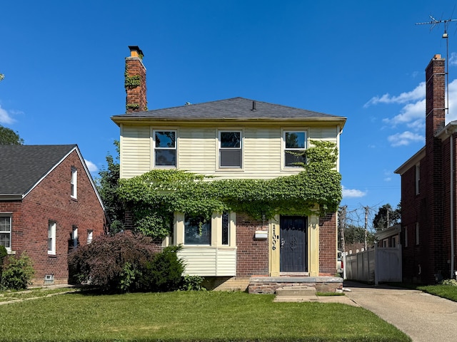 11006 Roxbury St, Detroit, MI 48224 - view of front of home featuring a front yard, brick siding, and a chimney