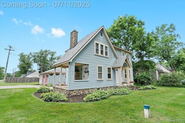 342 King St, Highland, MI 48357 - view of home's exterior featuring a chimney, a shingled roof, and a garage