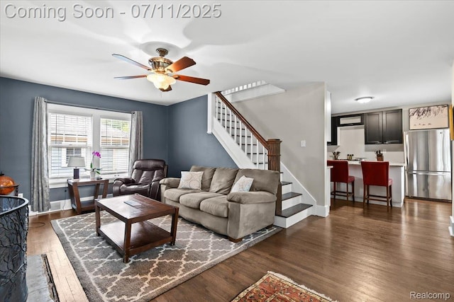 342 King St, Highland, MI 48357 - living area with dark wood-style floors, ceiling fan, and stairs