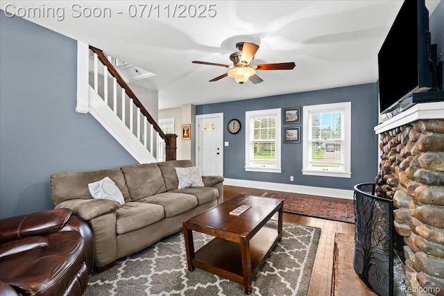 342 King St, Highland, MI 48357 - living area featuring a ceiling fan, stairway, wood finished floors, and a fireplace