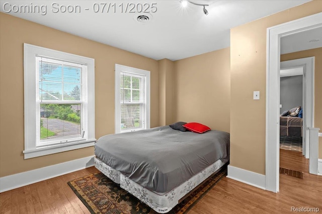 342 King St, Highland, MI 48357 - bedroom featuring wood finished floors and baseboards