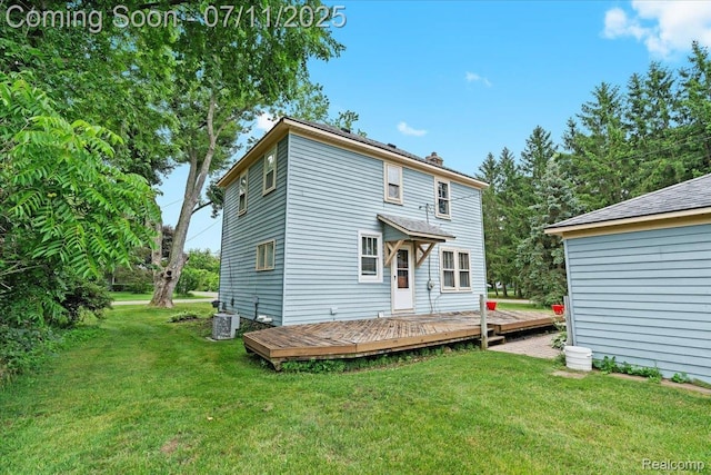 342 King St, Highland, MI 48357 - rear view of house with a wooden deck and a yard