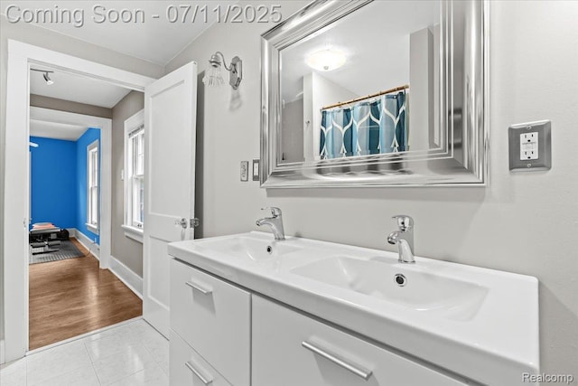 342 King St, Highland, MI 48357 - bathroom with double vanity, tile patterned floors, and curtained shower