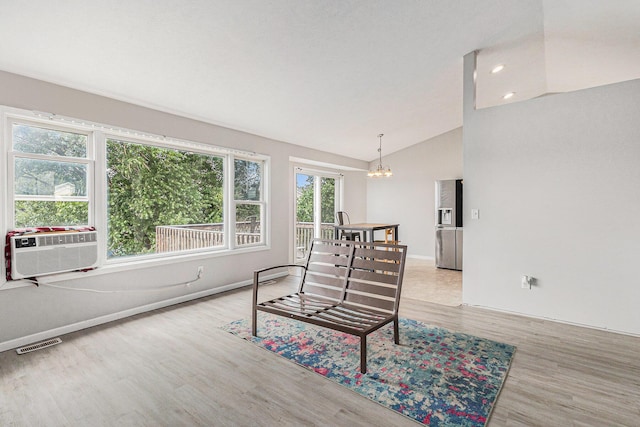 2953 Sunrise Ave, Holland, MI 49424 - living area featuring wood finished floors, a chandelier, lofted ceiling, and cooling unit