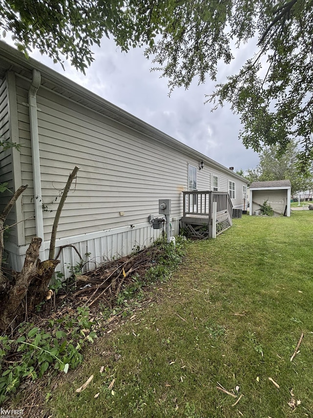 2500 Mann Rd, Clarkston, MI 48356 - view of home's exterior with a lawn and a wooden deck