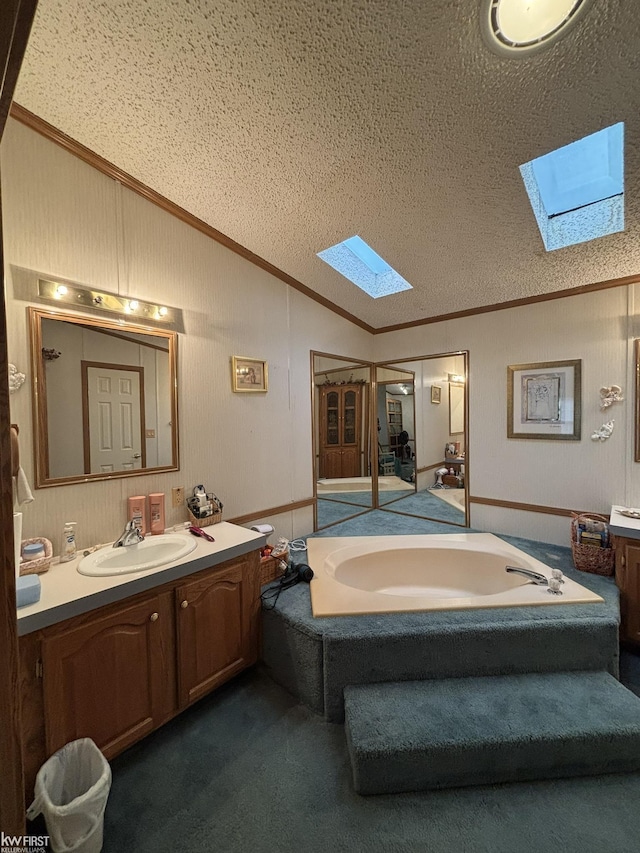 2500 Mann Rd, Clarkston, MI 48356 - bathroom featuring a skylight, lofted ceiling, crown molding, vanity, and a garden tub