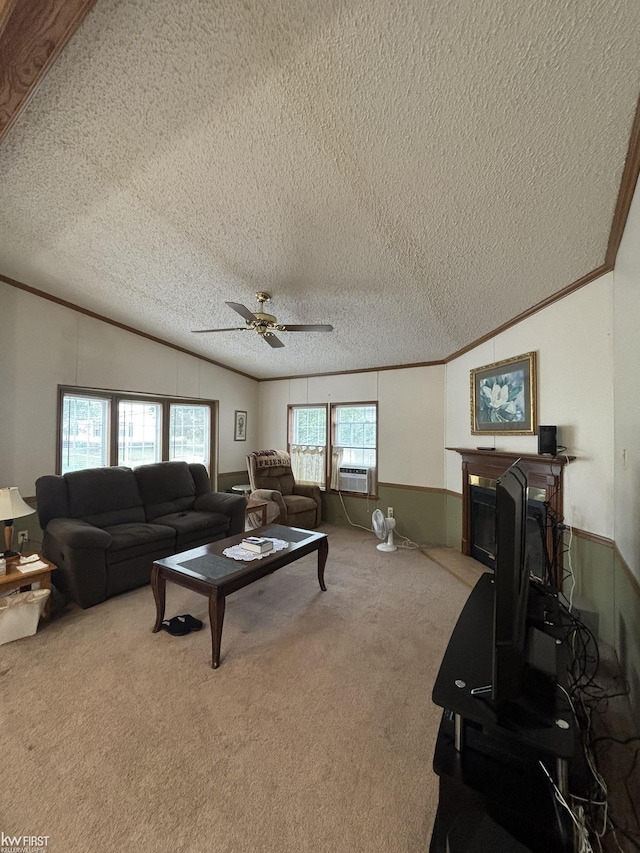 2500 Mann Rd, Clarkston, MI 48356 - carpeted living room featuring ornamental molding, lofted ceiling, ceiling fan, a glass covered fireplace, and a textured ceiling