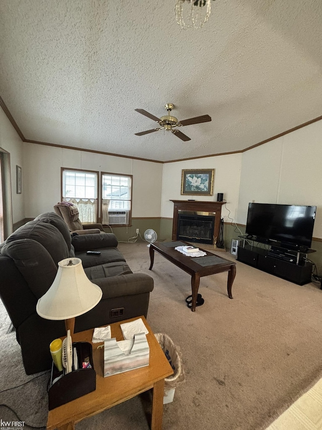 2500 Mann Rd, Clarkston, MI 48356 - carpeted living area with crown molding, a ceiling fan, a textured ceiling, and a glass covered fireplace