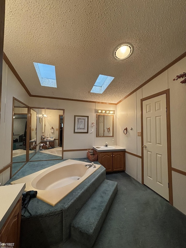 2500 Mann Rd, Clarkston, MI 48356 - bathroom featuring a skylight, ornamental molding, vaulted ceiling, a textured ceiling, and vanity