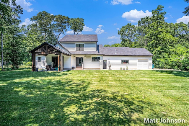 2771 Deer Run Rd, Muskegon, MI 49445 - back of house with an attached garage, a lawn, a patio, and a shingled roof