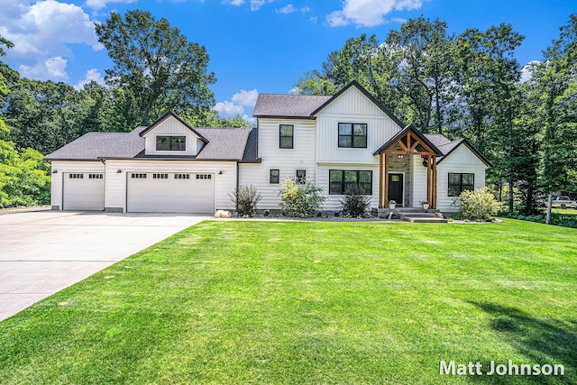 2771 Deer Run Rd, Muskegon, MI 49445 - modern inspired farmhouse featuring an attached garage, concrete driveway, and a front lawn