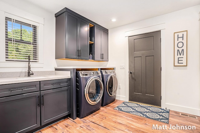 2771 Deer Run Rd, Muskegon, MI 49445 - washroom featuring cabinet space, washer and dryer, light wood-style floors, and recessed lighting