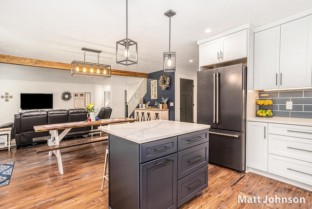 2771 Deer Run Rd, Muskegon, MI 49445 - kitchen with high quality fridge, white cabinets, a kitchen island, recessed lighting, and backsplash