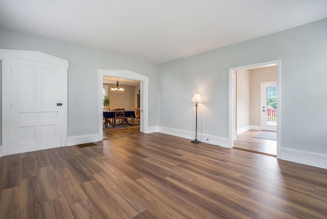 9148 Austin Rd, Saline, MI 48176 - unfurnished room with a chandelier and wood finished floors