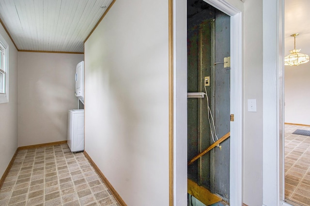 9148 Austin Rd, Saline, MI 48176 - hall with estacked washer and dryer, ornamental molding, and a chandelier