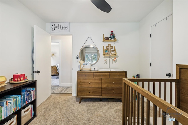 2641 Garfield Ave NW, Grand Rapids, MI 49544 - carpeted bedroom featuring a nursery area and a ceiling fan
