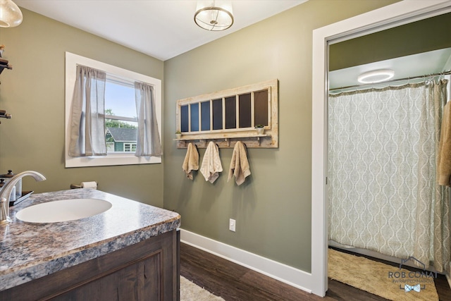 2641 Garfield Ave NW, Grand Rapids, MI 49544 - bathroom with wood finished floors, vanity, and curtained shower
