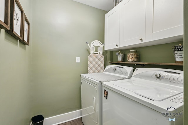 2641 Garfield Ave NW, Grand Rapids, MI 49544 - laundry room with cabinet space, washer and clothes dryer, and wood finished floors