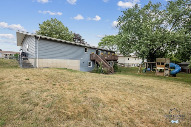 2641 Garfield Ave NW, Grand Rapids, MI 49544 - back of house featuring stairs, a wooden deck, and a playground