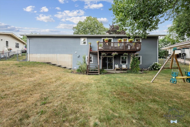 2641 Garfield Ave NW, Grand Rapids, MI 49544 - rear view of house featuring a wooden deck, stairway, and a playground