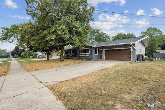 2641 Garfield Ave NW, Grand Rapids, MI 49544 - view of front of home with an attached garage, driveway, and a front yard