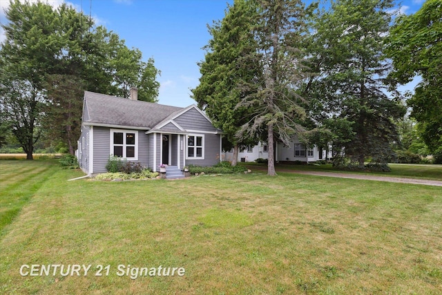 6357 Mackinaw Rd, Saginaw, MI 48604 - view of front of home featuring a chimney, a front yard, and roof with shingles