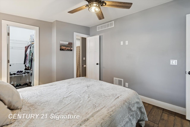 6357 Mackinaw Rd, Saginaw, MI 48604 - bedroom with wood finished floors, a closet, a walk in closet, and a ceiling fan