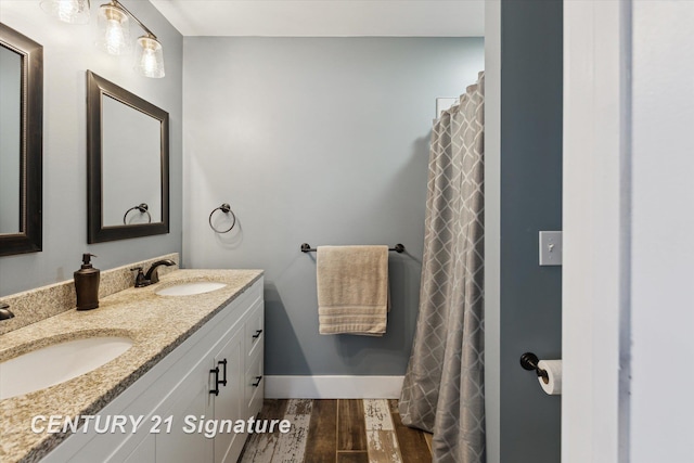 6357 Mackinaw Rd, Saginaw, MI 48604 - bathroom featuring wood finished floors and double vanity