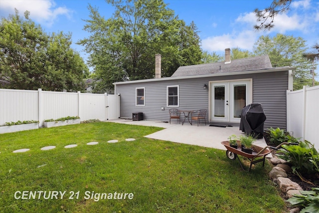 6357 Mackinaw Rd, Saginaw, MI 48604 - back of property with a fenced backyard, a patio area, french doors, and a chimney
