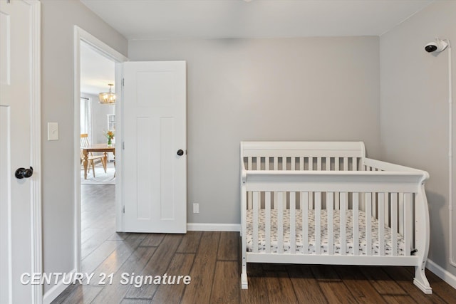 6357 Mackinaw Rd, Saginaw, MI 48604 - bedroom with wood finished floors, a chandelier, and a crib