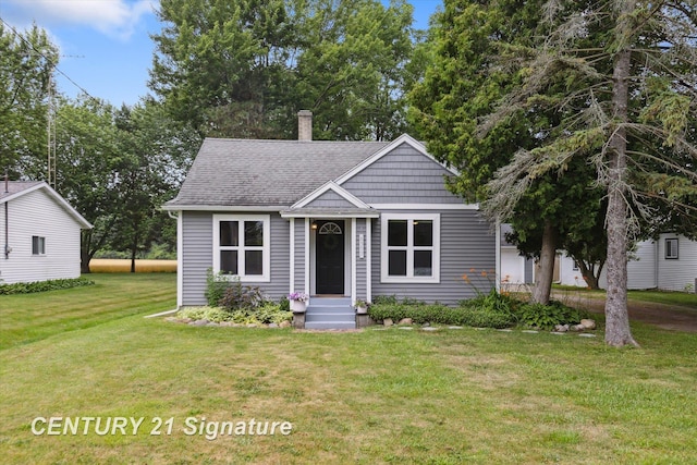 6357 Mackinaw Rd, Saginaw, MI 48604 - view of front of property with a front lawn, roof with shingles, and a chimney