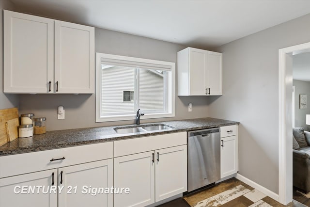6357 Mackinaw Rd, Saginaw, MI 48604 - kitchen with stainless steel dishwasher, white cabinets, and dark stone counters