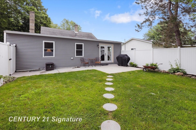 6357 Mackinaw Rd, Saginaw, MI 48604 - rear view of house featuring french doors, a chimney, a patio, and roof with shingles
