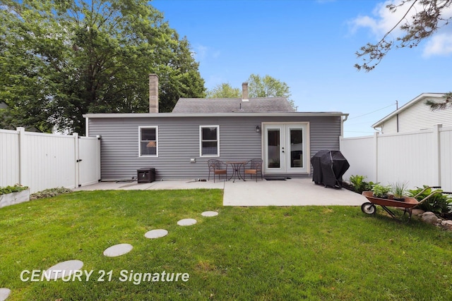 6357 Mackinaw Rd, Saginaw, MI 48604 - rear view of property featuring a patio, a fenced backyard, and french doors