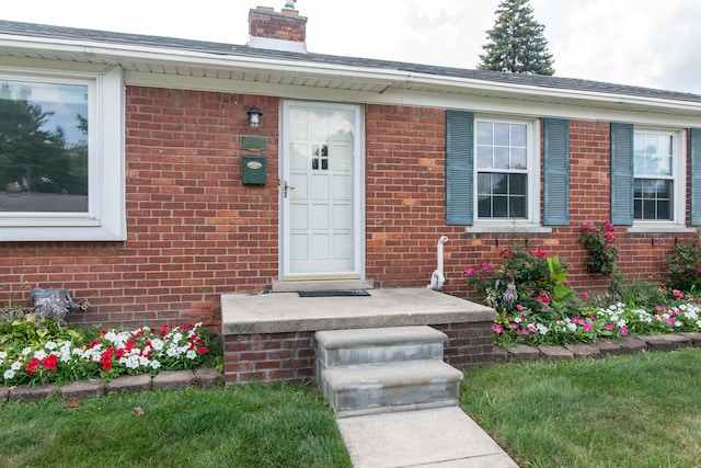 11015 Fairfield St, Livonia, MI 48150 - property entrance with a chimney and brick siding