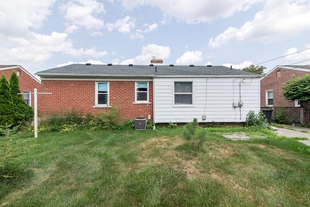 11015 Fairfield St, Livonia, MI 48150 - rear view of property with brick siding and a chimney