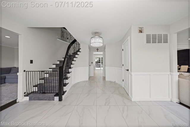 5534 Apple Ridge Trl, West Bloomfield, MI 48322 - entrance foyer with light marble finish flooring, stairs, a chandelier, and wainscoting