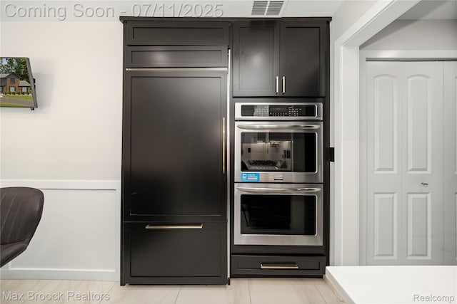 5534 Apple Ridge Trl, West Bloomfield, MI 48322 - kitchen with double oven, light countertops, paneled fridge, and light tile patterned floors
