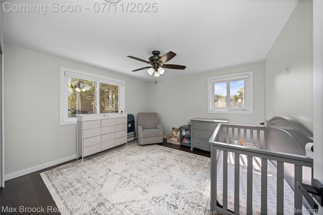 5534 Apple Ridge Trl, West Bloomfield, MI 48322 - bedroom featuring multiple windows, wood finished floors, a nursery area, and ceiling fan