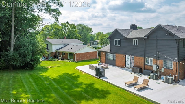 5534 Apple Ridge Trl, West Bloomfield, MI 48322 - back of property with brick siding, a patio, a yard, a chimney, and roof with shingles