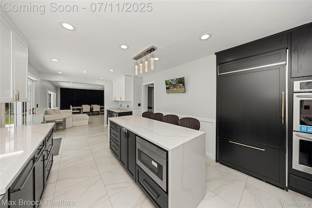 5534 Apple Ridge Trl, West Bloomfield, MI 48322 - kitchen featuring appliances with stainless steel finishes, light marble finish floors, recessed lighting, open floor plan, and light stone countertops