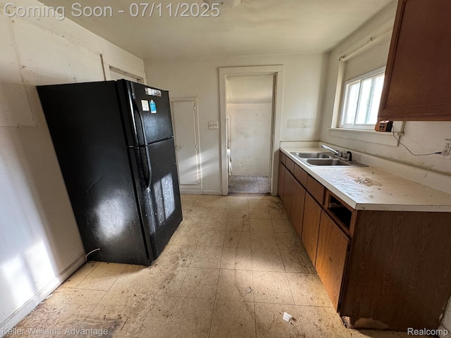 285 Voorheis St, Pontiac, MI 48341 - kitchen featuring freestanding refrigerator, light countertops, and brown cabinets