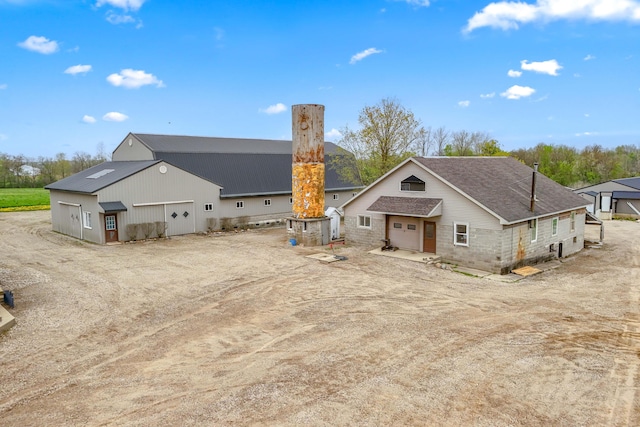 810 Newton Rd, Coldwater, MI 49036 - back of house with a garage and a shingled roof