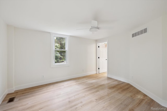 11240 Silver Lake Rd, Byron, MI 48418 - unfurnished room featuring light wood-style flooring and a ceiling fan