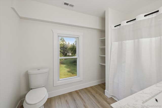 11240 Silver Lake Rd, Byron, MI 48418 - bathroom with wood finished floors, a shower with curtain, and vanity